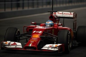 Alonso drives his F14 T in the pit lane during pre-season testing at the Jerez racetrack