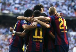 Barcelona's players celebrate a goal against Real Madrid during their Spanish first division "Clasico" soccer match at the Santiago Bernabeu stadium in Madrid